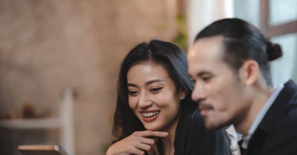 Couple reviewing information together on a tablet, representing shared property investment planning and long-term financial goals