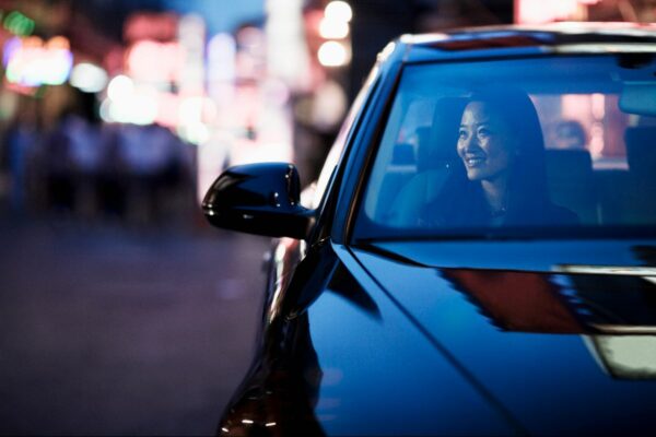Woman smiling inside a car at night, highlighting easier daily commutes near Haraya Residences