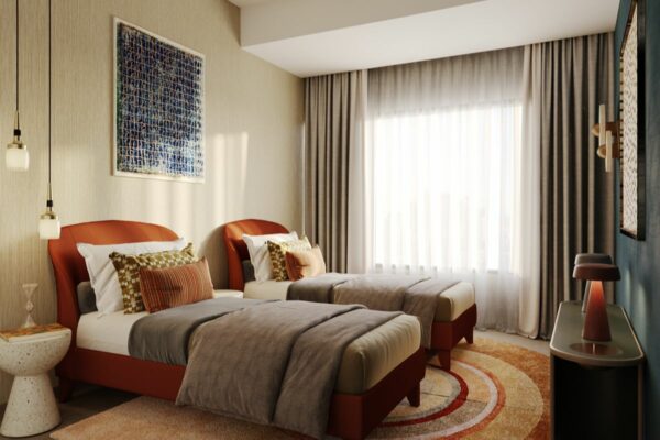 Stylish second bedroom with twin beds, decorative lighting, artwork, and floor-to-ceiling curtains